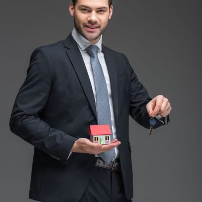 real-estate-agent-holding-house-model-and-key-iso-2026-01-06-00-35-11-utc_optimized_200